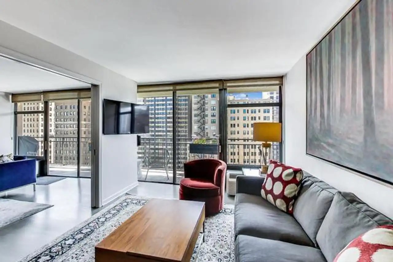 1430 North Astor Street, Unit 19C Chicago, IL 60610 - Photo 13 of 41 a living room with furniture and a large window