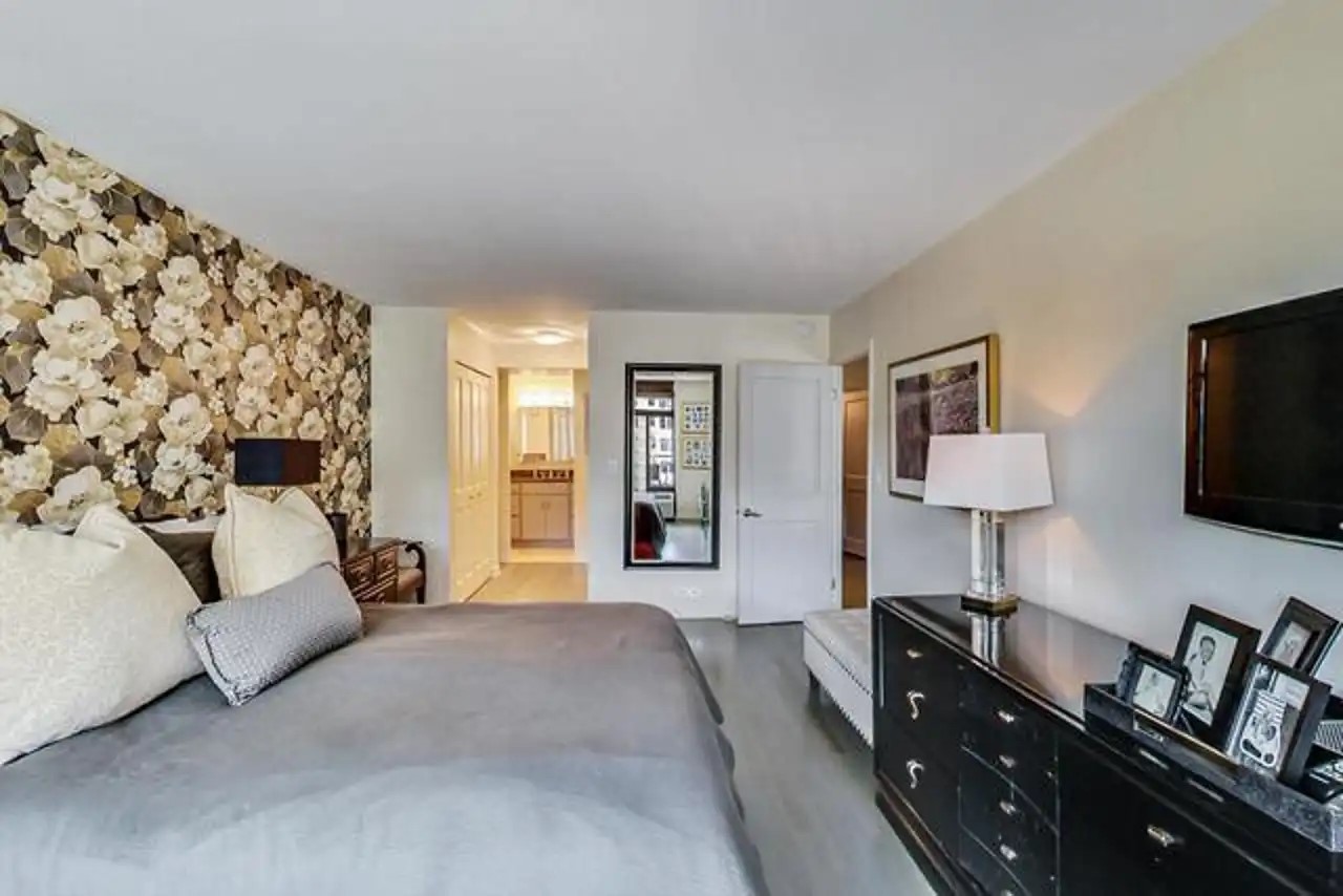 1430 North Astor Street, Unit 19C Chicago, IL 60610 - Photo 16 of 41 a bedroom with a bed and a flat screen television