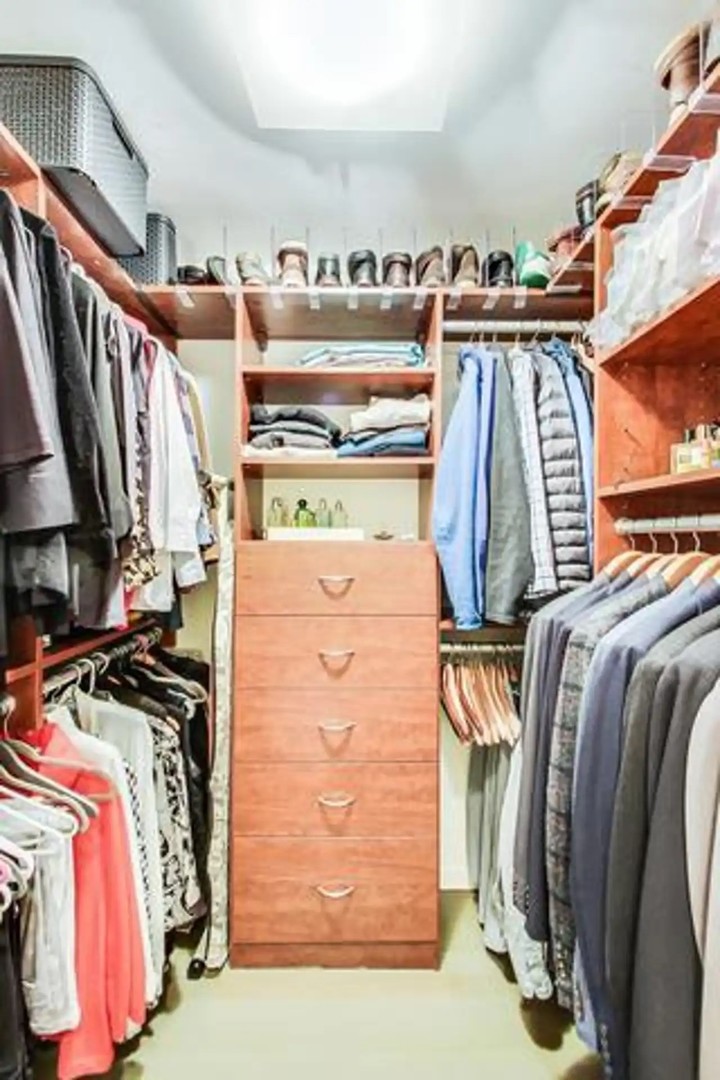 1430 North Astor Street, Unit 19C Chicago, IL 60610 - Photo 19 of 41 a view of walk in closet with clothes and shoes