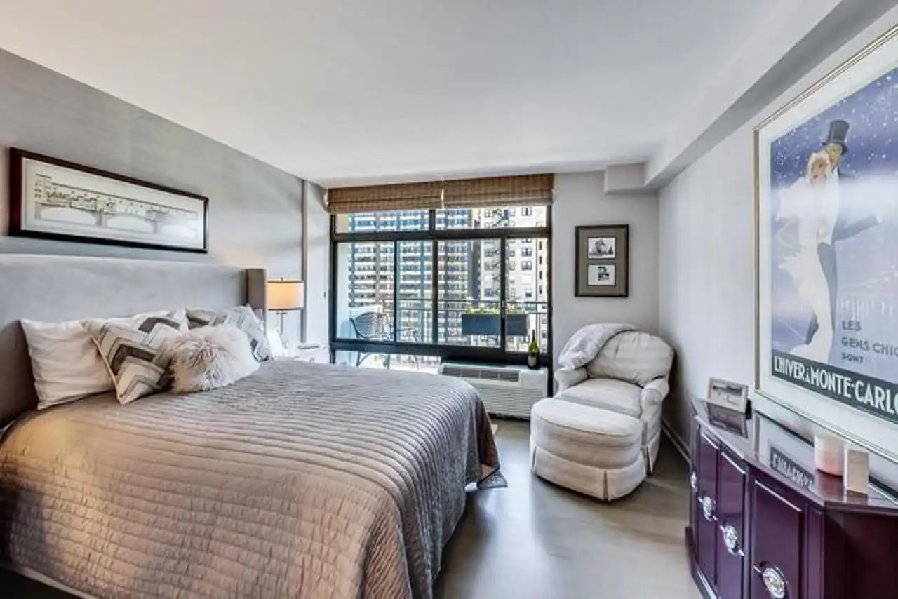 1430 North Astor Street, Unit 19C Chicago, IL 60610 - Photo 20 of 41 a bedroom with a bed couch and a window