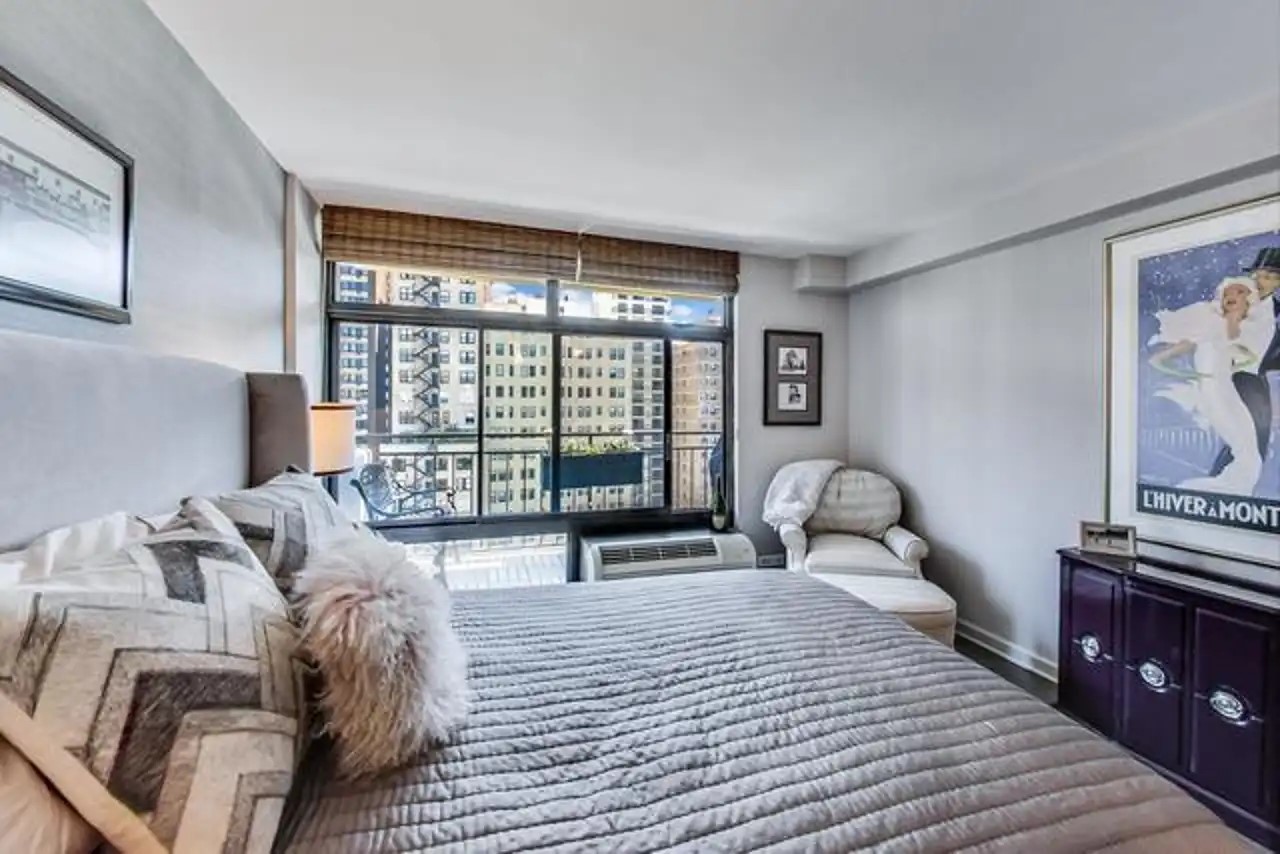 1430 North Astor Street, Unit 19C Chicago, IL 60610 - Photo 22 of 41 a bedroom with furniture and a window