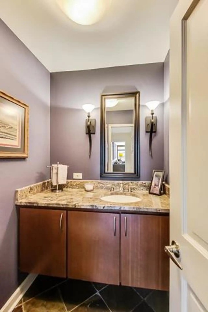 1430 North Astor Street, Unit 19C Chicago, IL 60610 - Photo 24 of 41 a bathroom with a granite countertop sink and a mirror