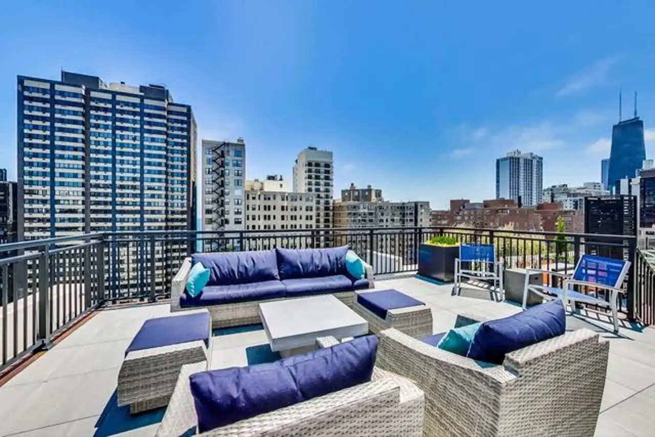 1430 North Astor Street, Unit 19C Chicago, IL 60610 - Photo 30 of 41 a view of roof deck with seating space and city view