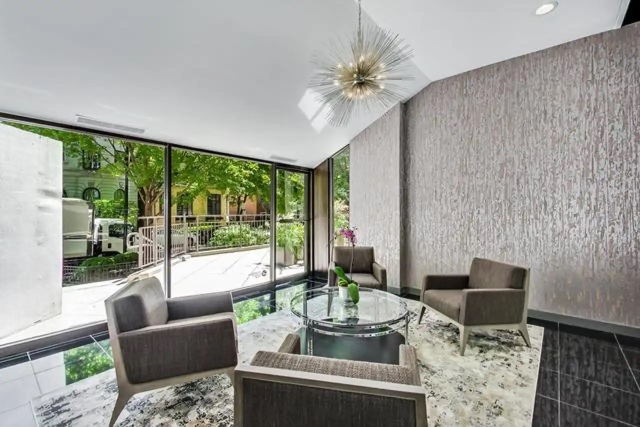 1430 North Astor Street, Unit 19C Chicago, IL 60610 - Photo 39 of 41 a living room with furniture and a floor to ceiling window