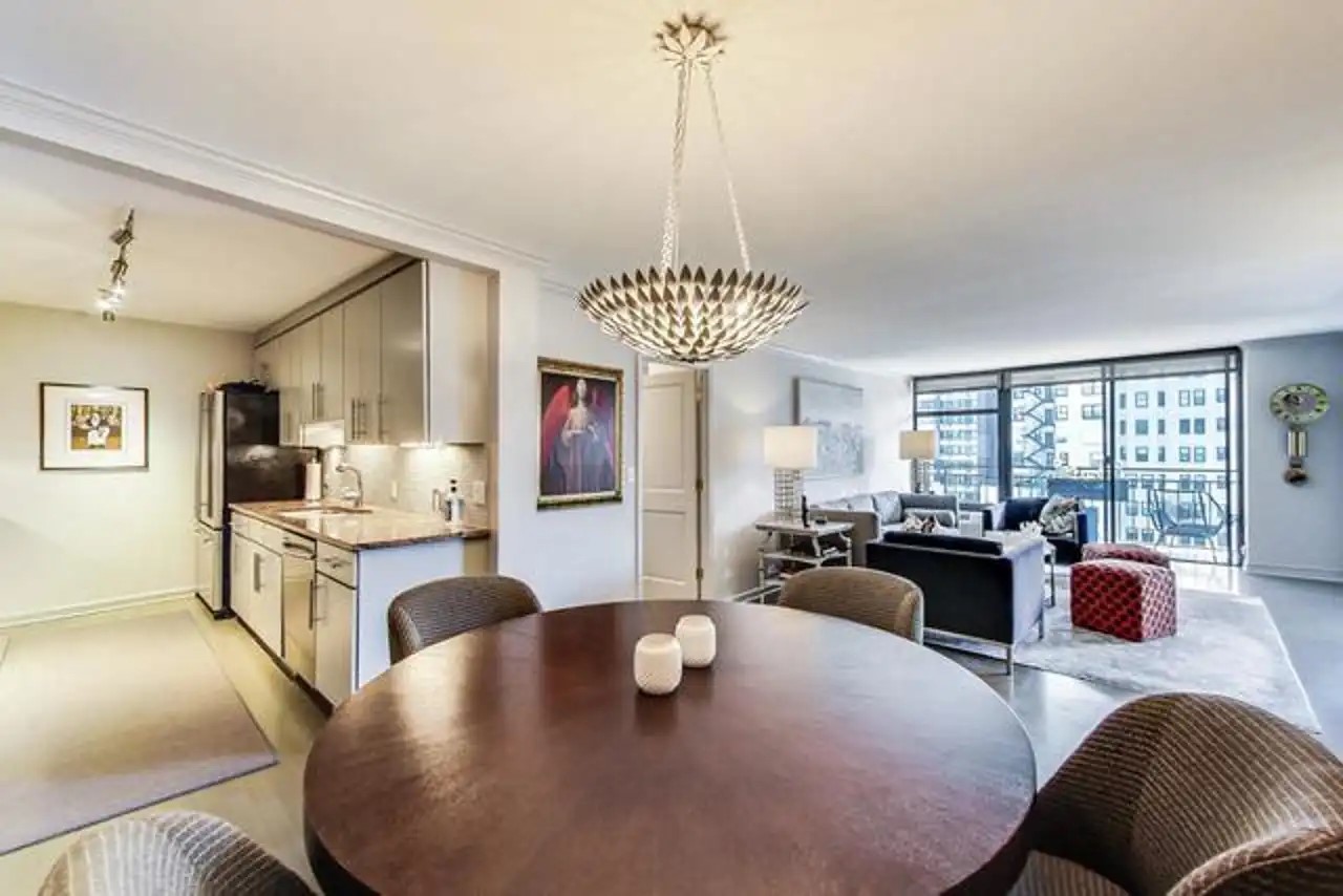 1430 North Astor Street, Unit 19C Chicago, IL 60610 - Photo 7 of 41 a large living room with couches a dining table and chairs