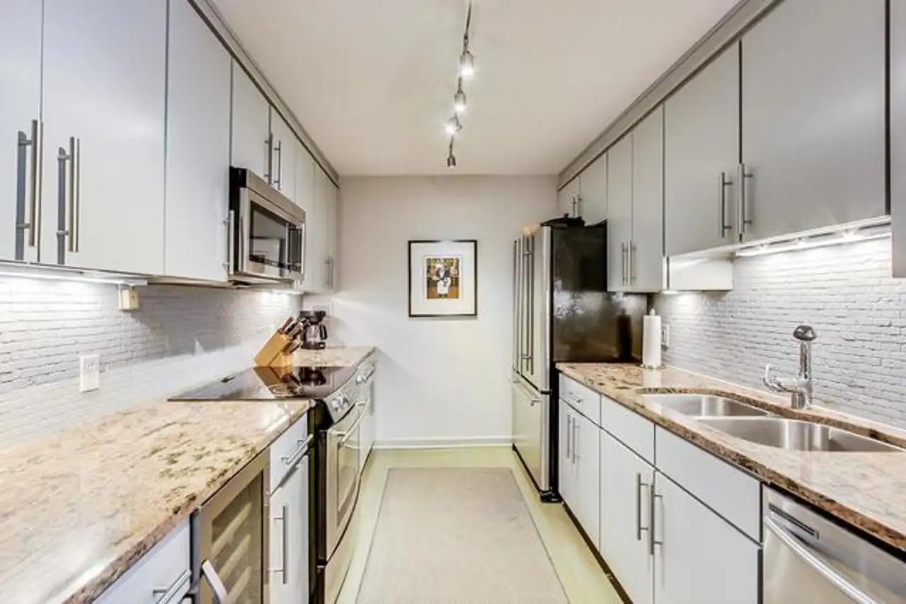 1430 North Astor Street, Unit 19C Chicago, IL 60610 - Photo 9 of 41 a kitchen with a sink stove and refrigerator