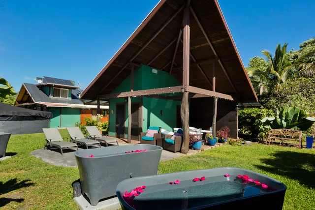 a view of a house with backyard and sitting area