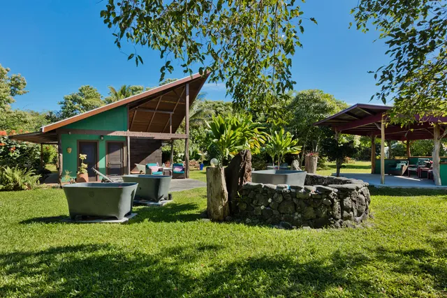 a view of house with swimming pool and sitting area