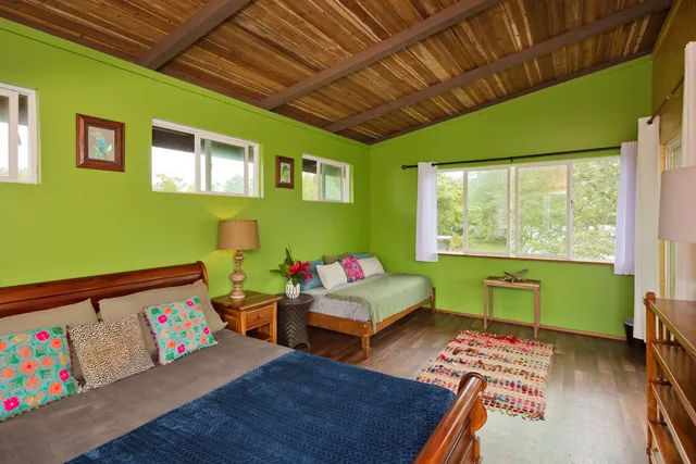 a bed sitting in a bedroom next to a window