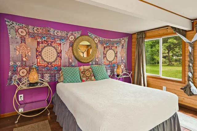 a green field with some trees in the background