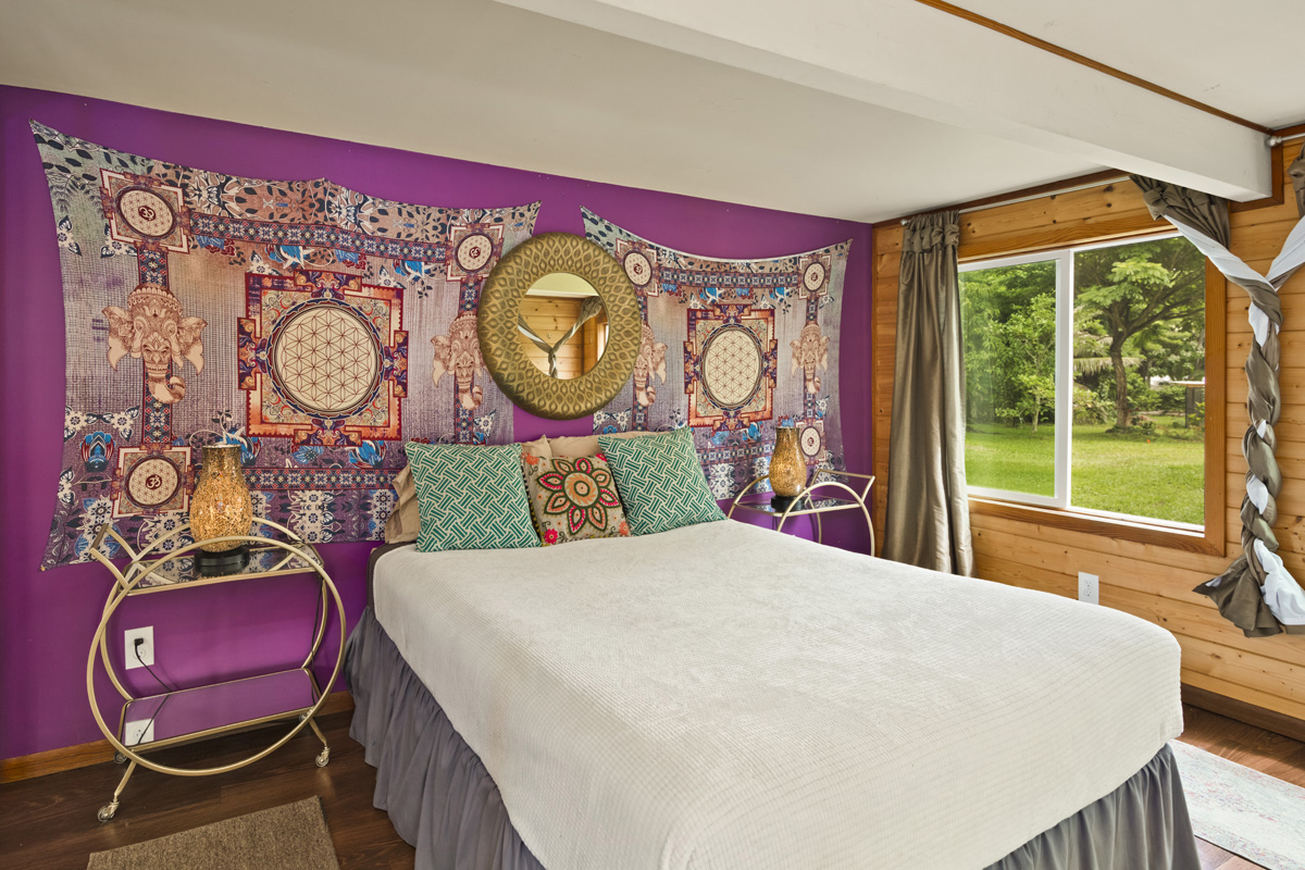 13-353 Kamaili Road Pahoa, HI 96778 - Photo 24 of 30 a bed sitting in a bedroom next to a window