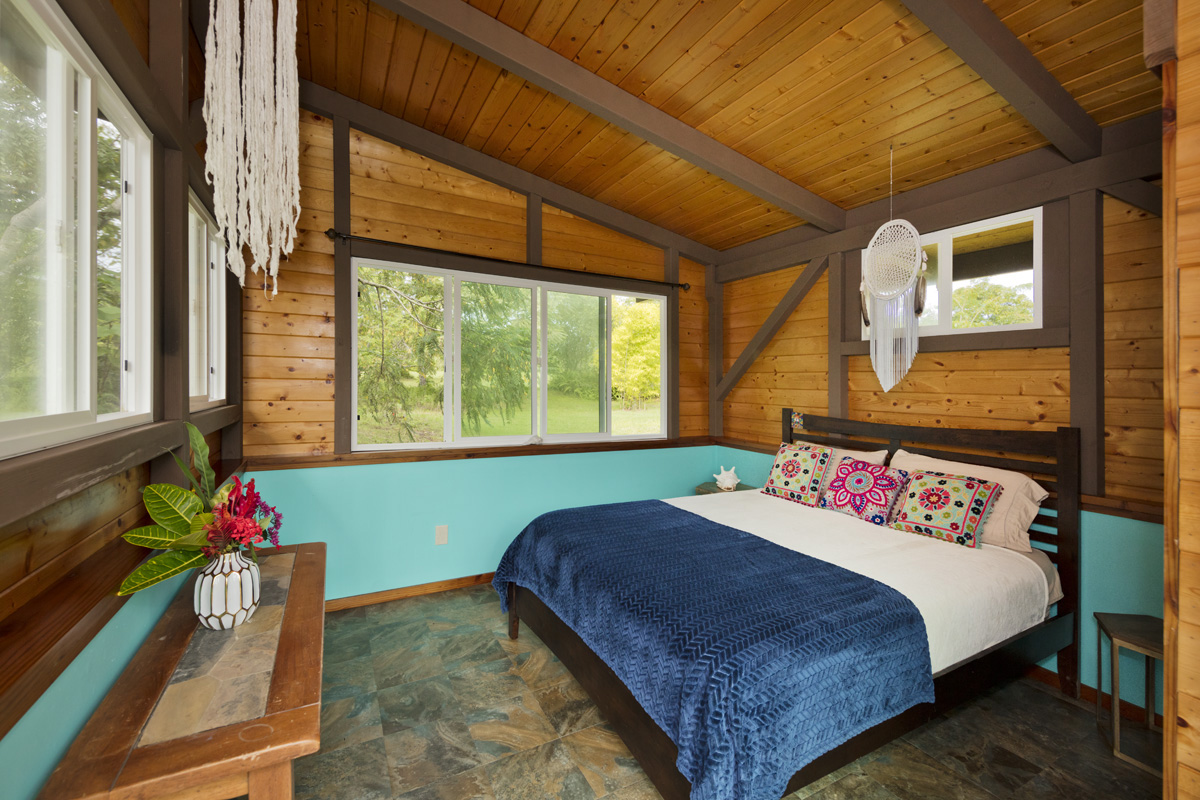 13-353 Kamaili Road Pahoa, HI 96778 - Photo 27 of 30 a bed sitting in a bedroom next to a window