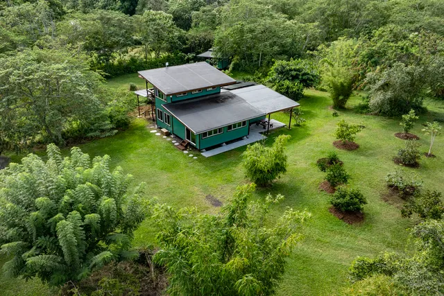 an aerial view of a house with pool yard and outdoor seating