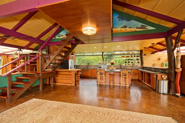 a dining room with wooden floor furniture and a large window