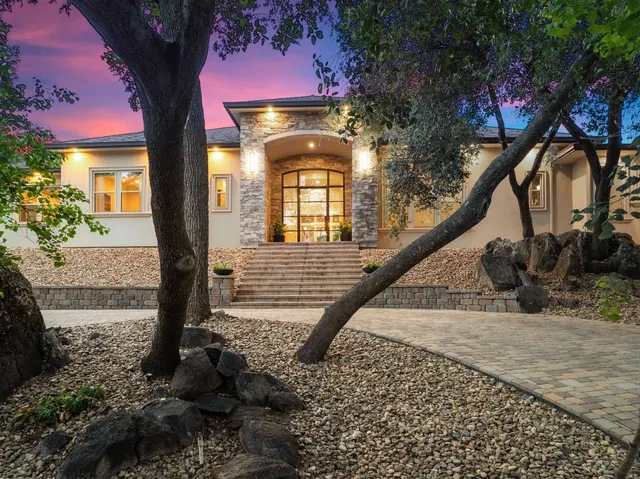 an aerial view of a house with a garden and trees
