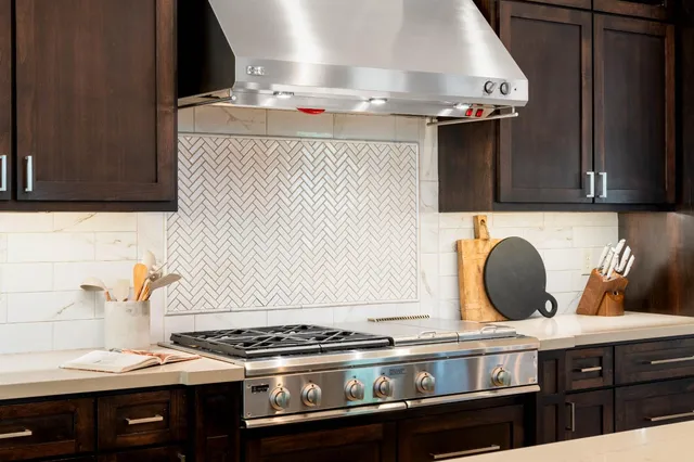 a living room with furniture a flat screen tv and windows