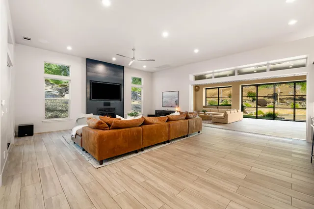 a spacious bedroom with a bed and a flat screen tv