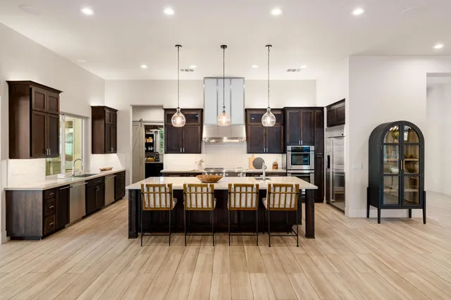 a living room with furniture kitchen view and a fireplace