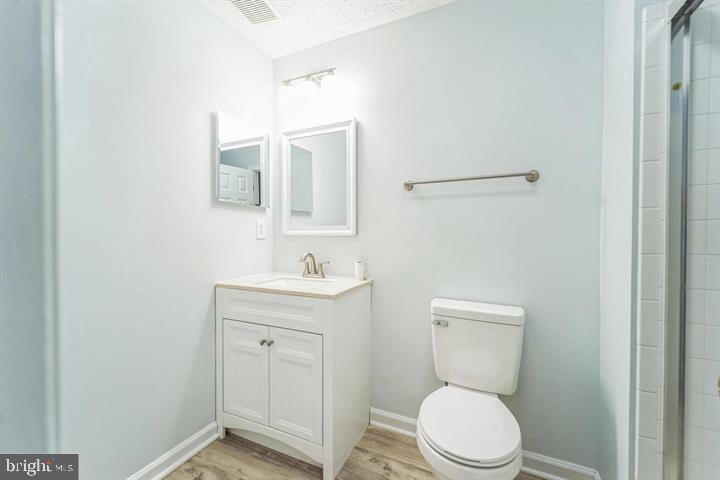 11 Gemstone Court Baltimore, MD 21244 - Photo 16 of 19 a bathroom with a toilet a sink a vanity and mirror