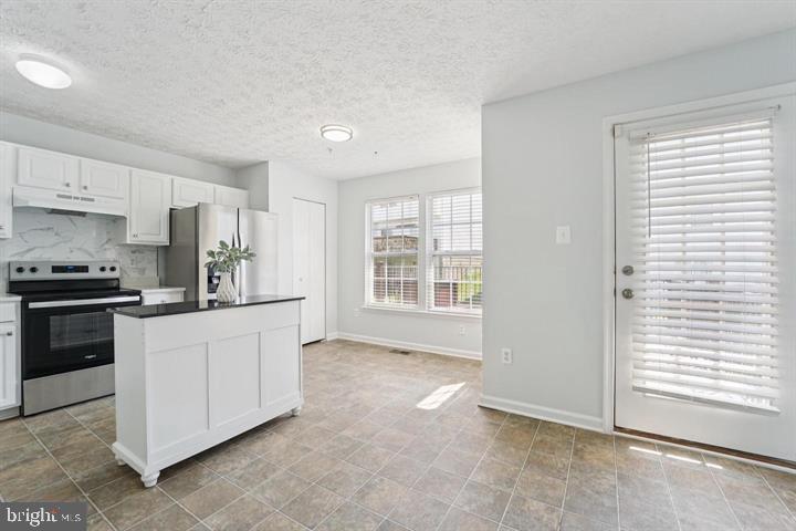 11 Gemstone Court Baltimore, MD 21244 - Photo 6 of 19 a kitchen with granite countertop white cabinets and white appliances