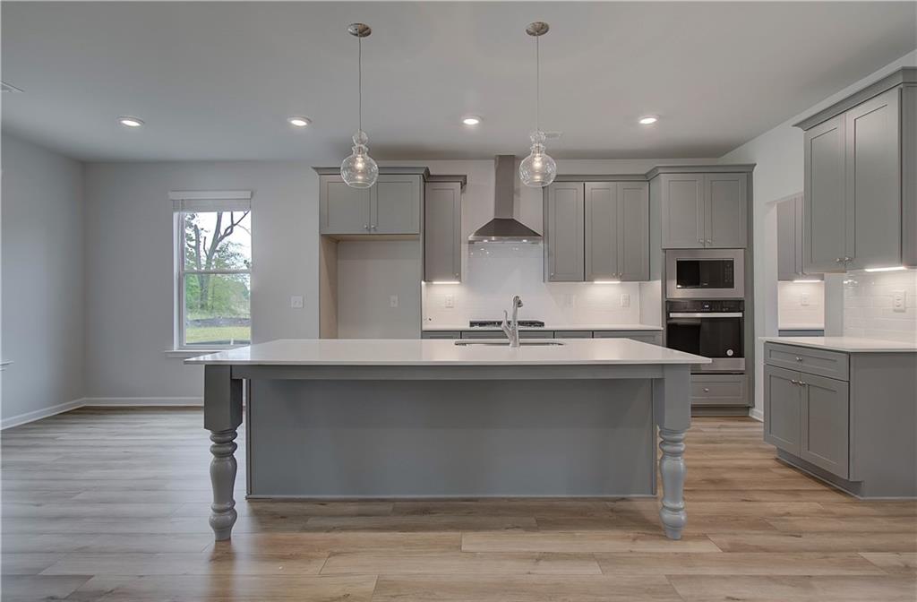 116 Haverling Pass Hampton, GA 30228 - Photo 11 of 38 a kitchen with kitchen island a sink a stove a refrigerator and a stove