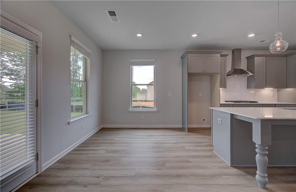 116 Haverling Pass Hampton, GA 30228 - Photo 13 of 38 a view of kitchen with stove and wooden cabinets