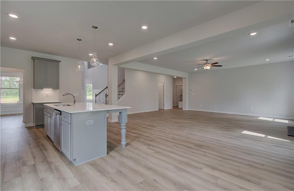 116 Haverling Pass Hampton, GA 30228 - Photo 15 of 38 a view of kitchen island with stainless steel appliances furniture large window and wooden floor