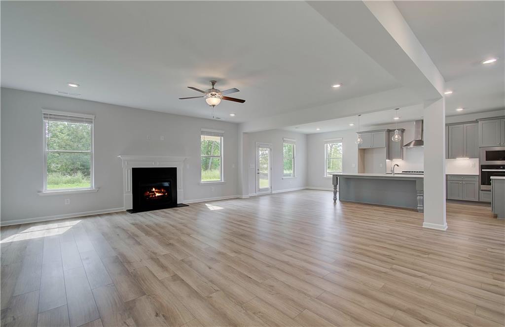 116 Haverling Pass Hampton, GA 30228 - Photo 18 of 38 a view of an empty room with a fireplace and a window