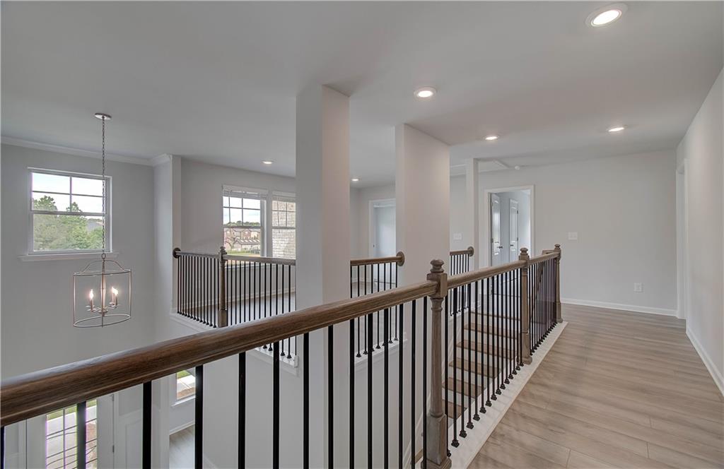 116 Haverling Pass Hampton, GA 30228 - Photo 25 of 38 a view of a hallway with wooden floor and windows