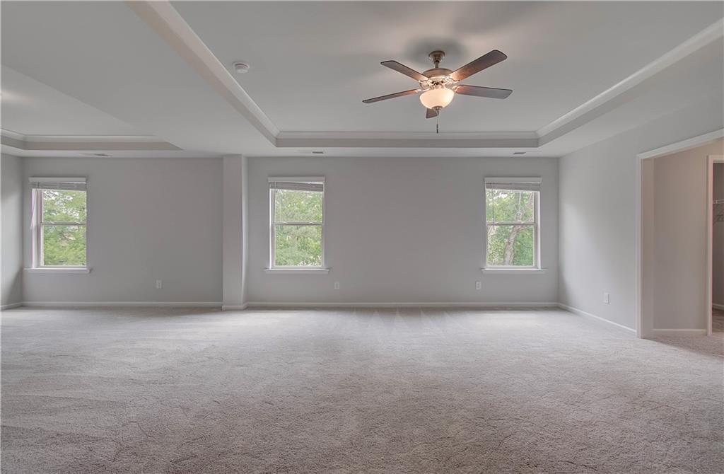 116 Haverling Pass Hampton, GA 30228 - Photo 27 of 38 an empty room with windows and ceiling fan