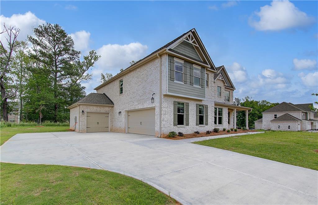 116 Haverling Pass Hampton, GA 30228 - Photo 3 of 38 a front view of a house with garden