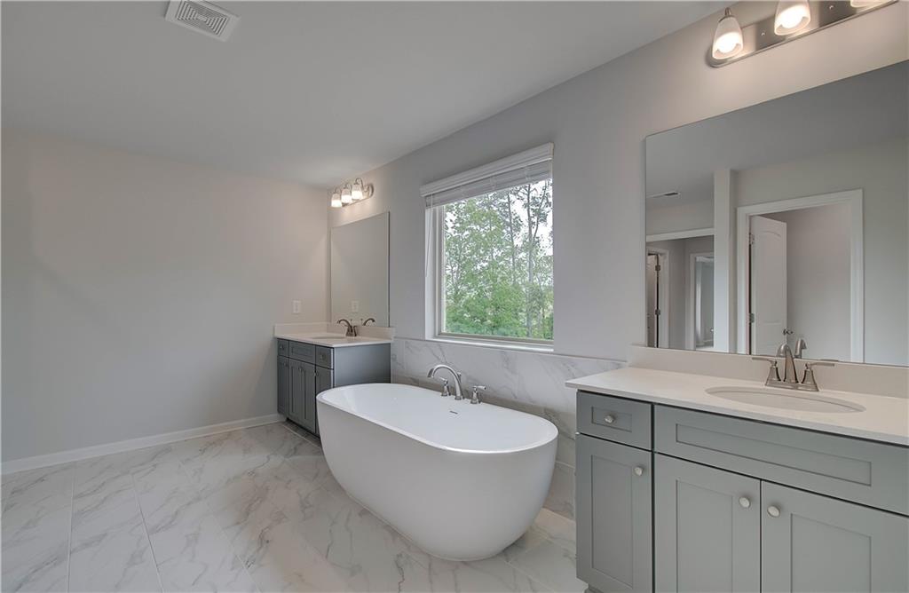 116 Haverling Pass Hampton, GA 30228 - Photo 34 of 38 a bathroom with a sink and a mirror