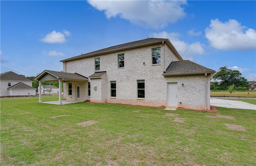 116 Haverling Pass Hampton, GA 30228 - Photo 38 of 38 a front view of a house with a yard and garage