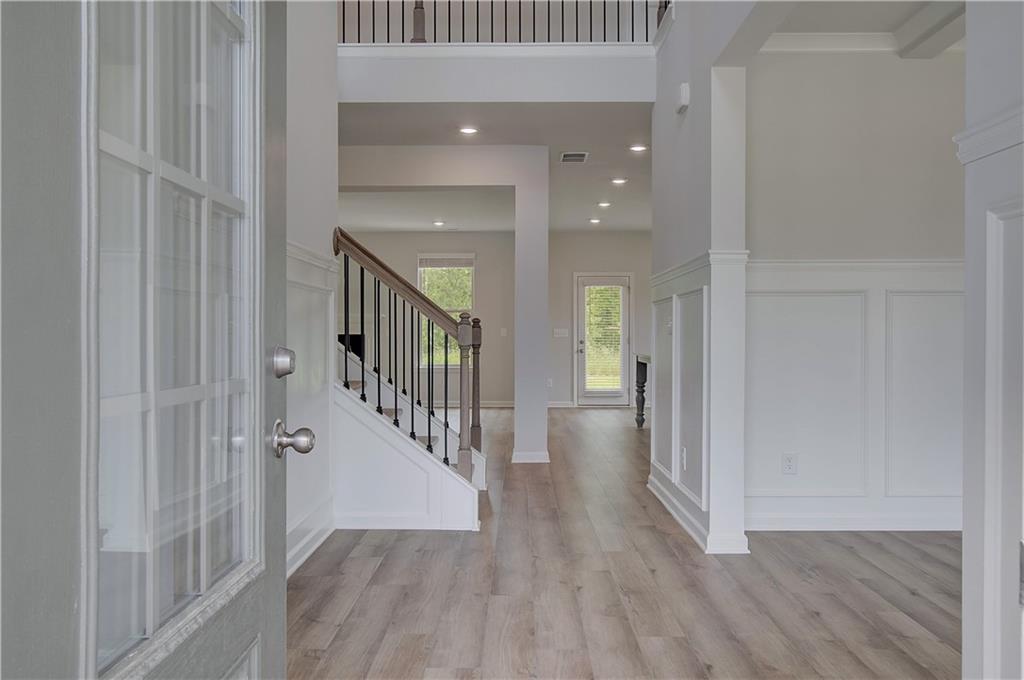 116 Haverling Pass Hampton, GA 30228 - Photo 5 of 38 a view of a hallway with wooden floor and entryway