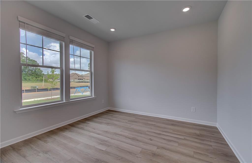 116 Haverling Pass Hampton, GA 30228 - Photo 7 of 38 an empty room with wooden floor and windows