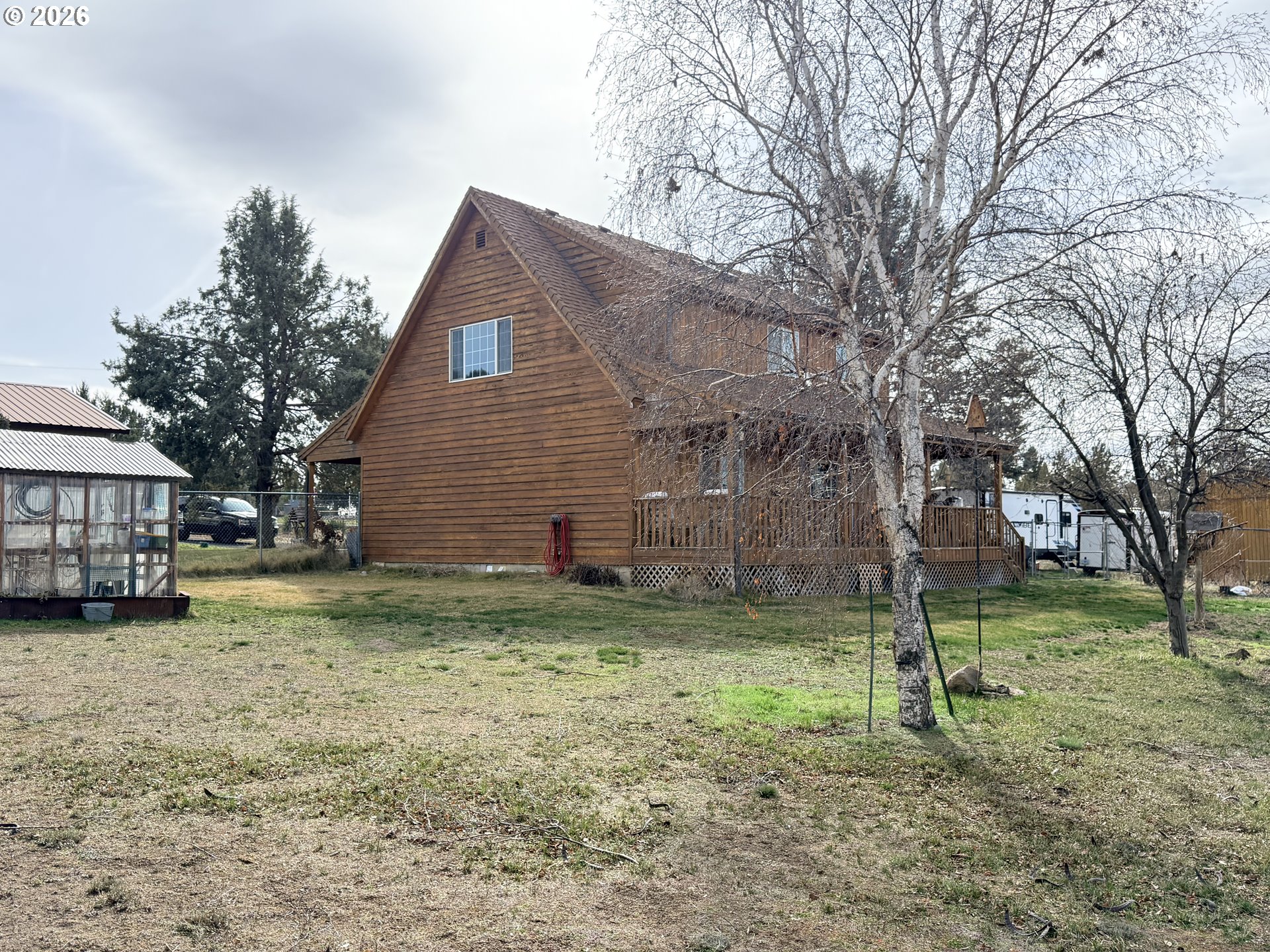 8818 Southwest Panorama Road Terrebonne, OR 97760 - Photo 17 of 46 a backyard of a house with plants and large tree
