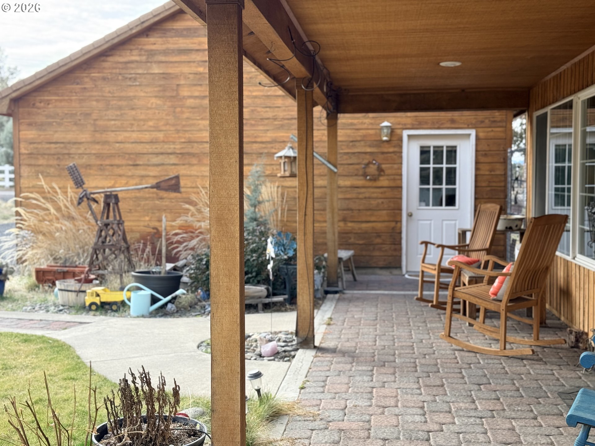 8818 Southwest Panorama Road Terrebonne, OR 97760 - Photo 2 of 46 a view of a patio with a dining table and chairs