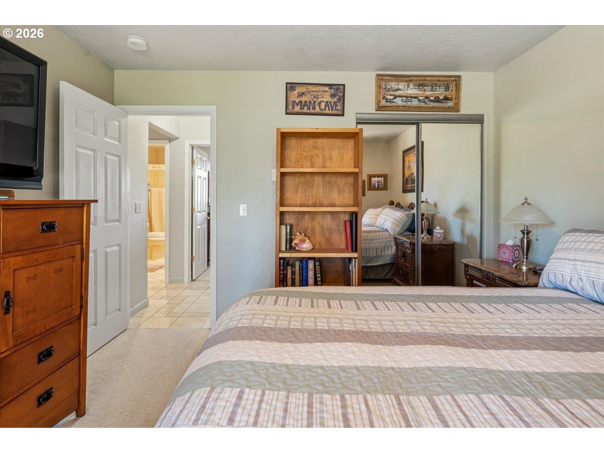 8818 Southwest Panorama Road Terrebonne, OR 97760 - Photo 21 of 46 a bedroom with a bed and a flat tv screen on dresser