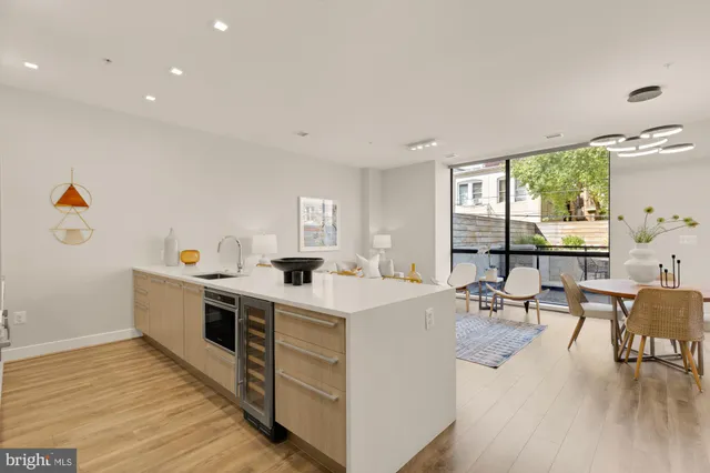 a kitchen with a stove and a wooden floor