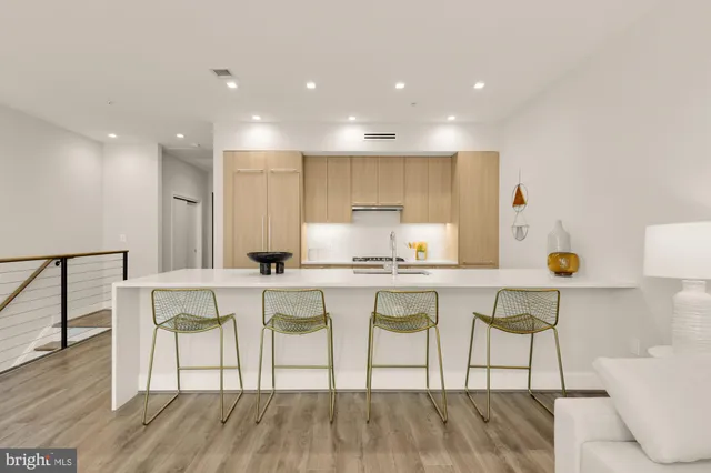 a kitchen that has a sink a stove and a wooden floor