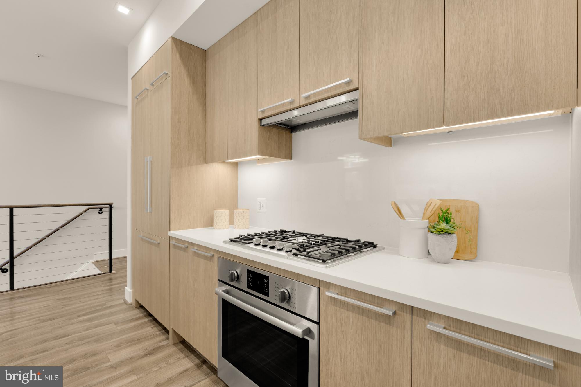 1628 11th Street Northwest, Unit 105 Washington, DC 20001 - Photo 10 of 55 a kitchen with a stove and a wooden floor