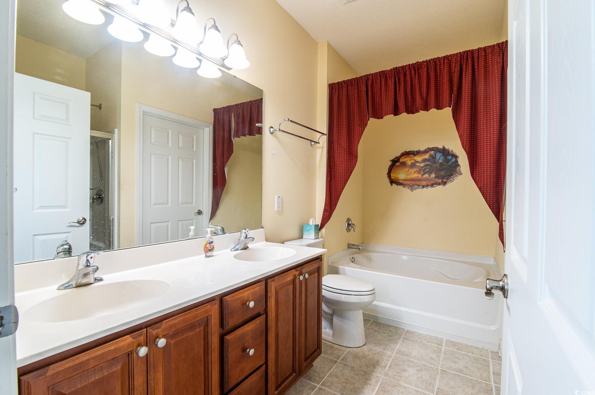 111 Rose Water Loop Myrtle Beach, SC 29588 - Photo 15 of 39 Full bathroom featuring a garden tub, double vanit