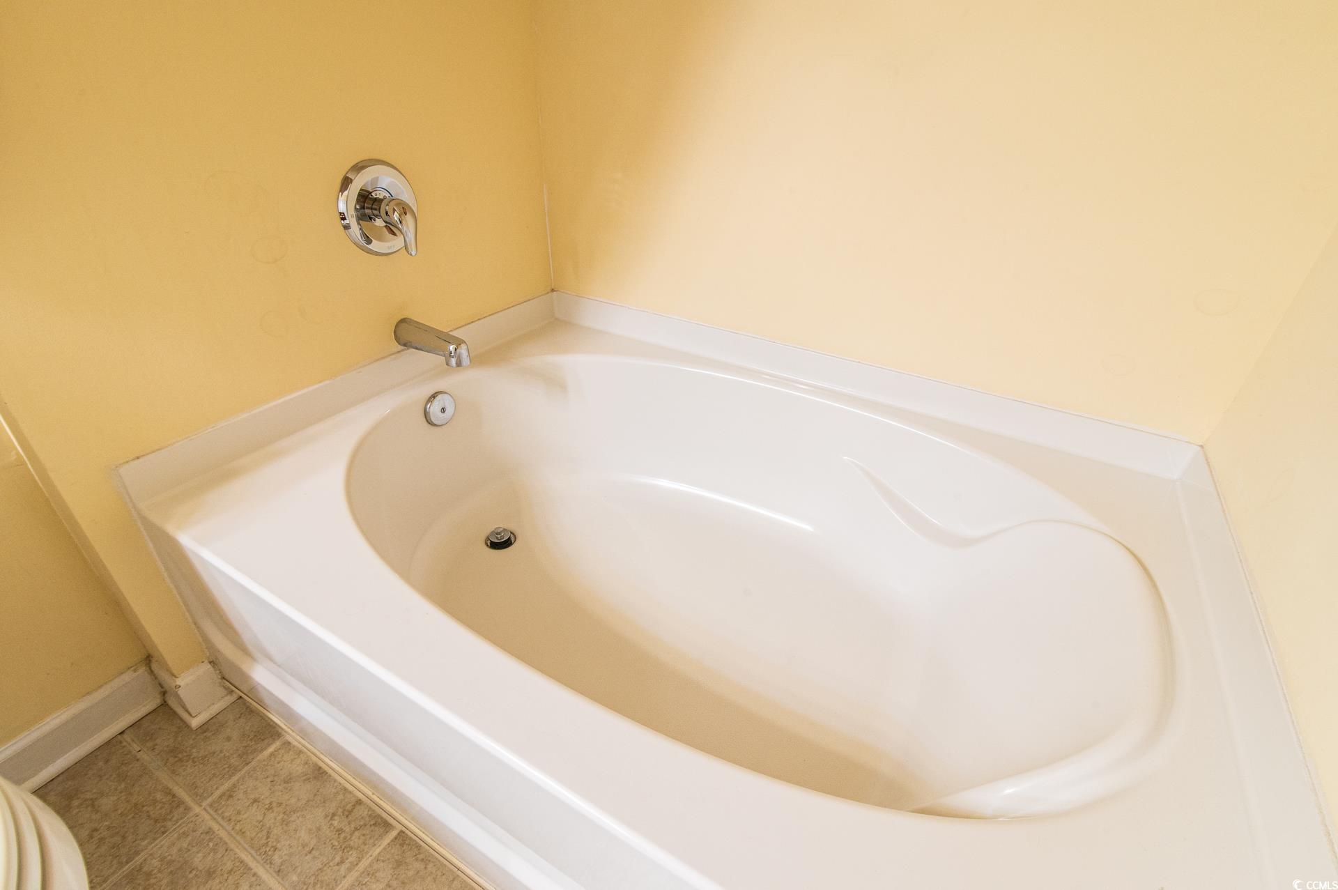 111 Rose Water Loop Myrtle Beach, SC 29588 - Photo 16 of 39 Bathroom with tile patterned flooring and a bathtu