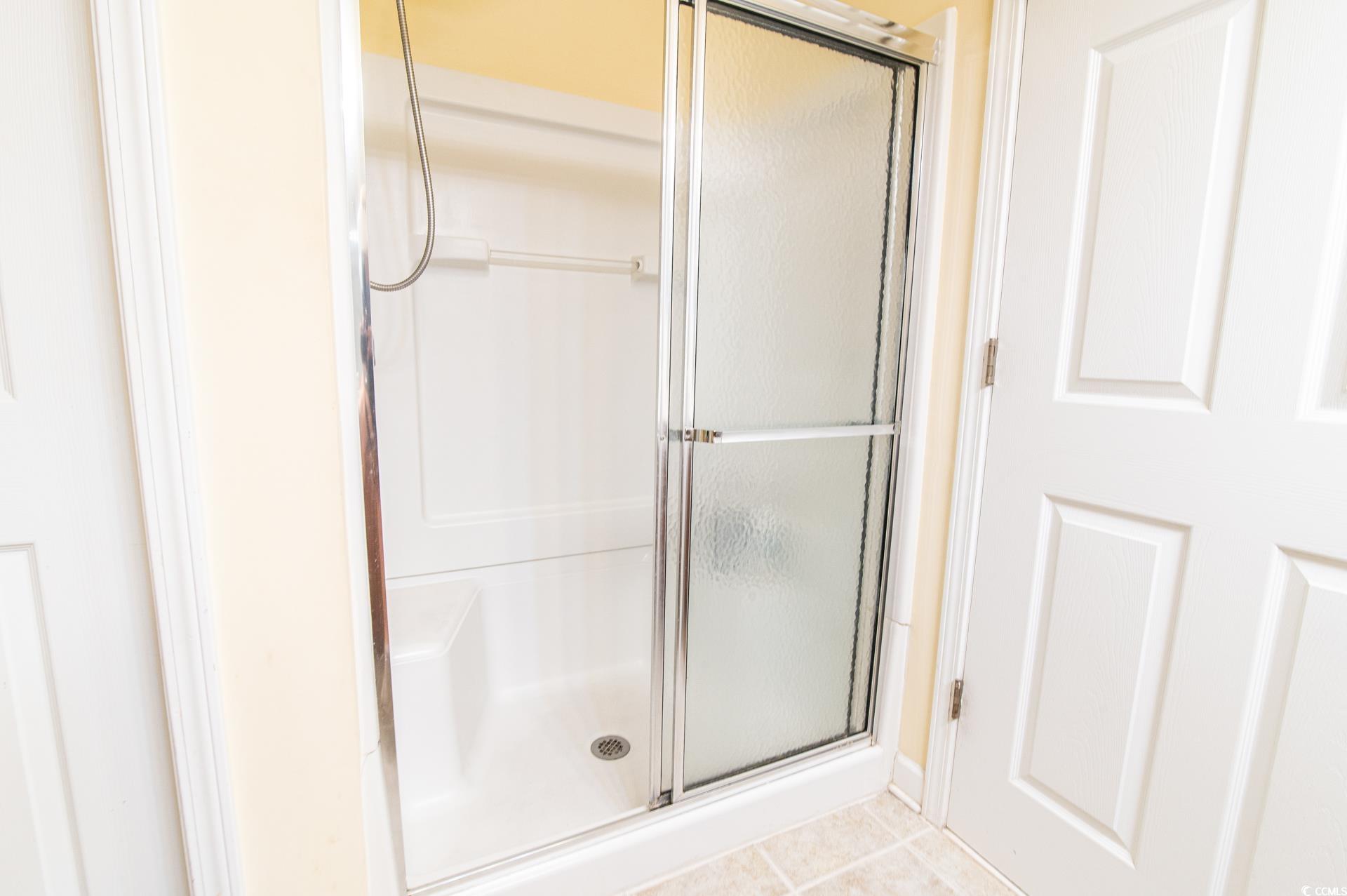 111 Rose Water Loop Myrtle Beach, SC 29588 - Photo 17 of 39 Bathroom with a shower stall and tile patterned fl