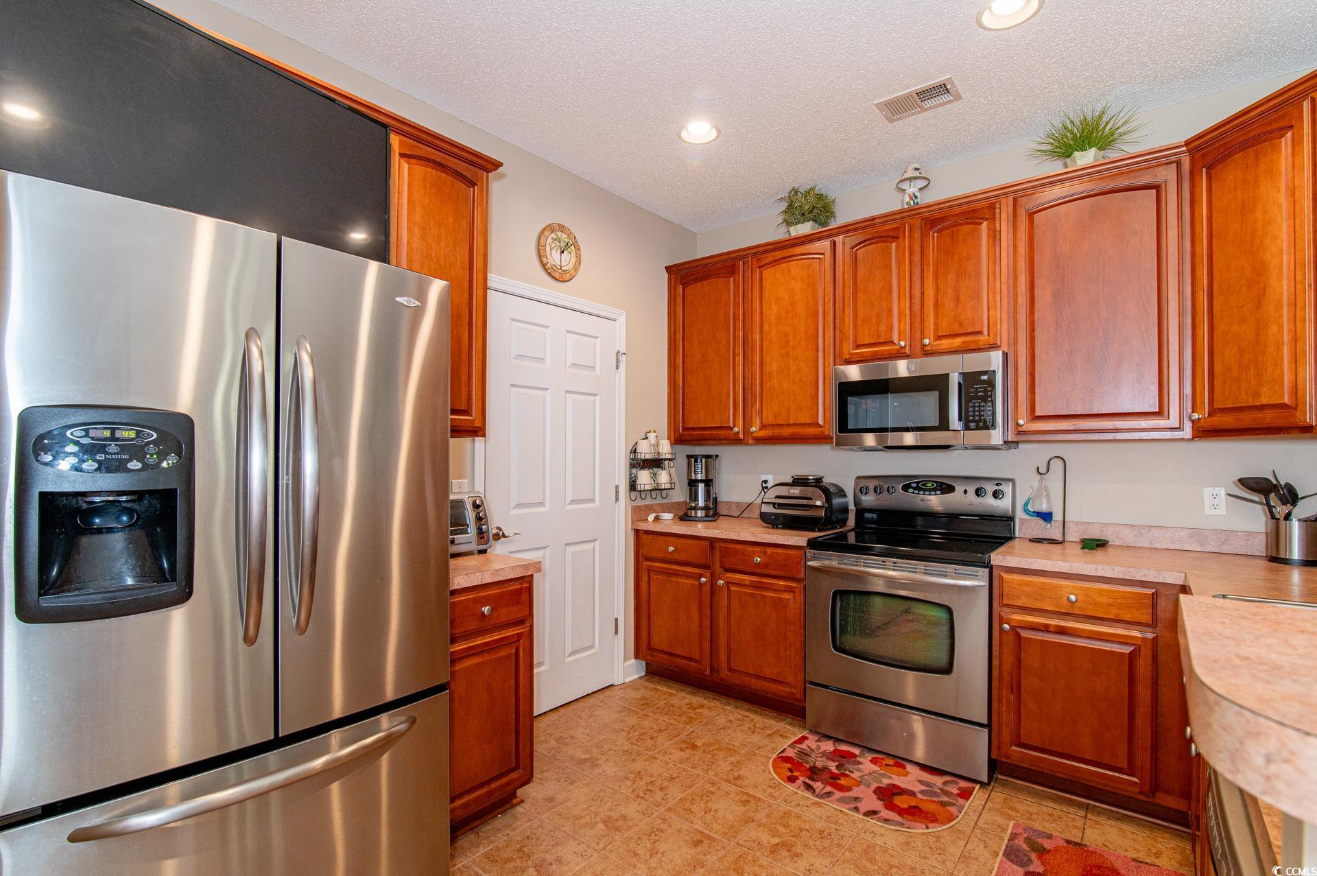 111 Rose Water Loop Myrtle Beach, SC 29588 - Photo 18 of 39 Kitchen with stainless steel appliances, light cou