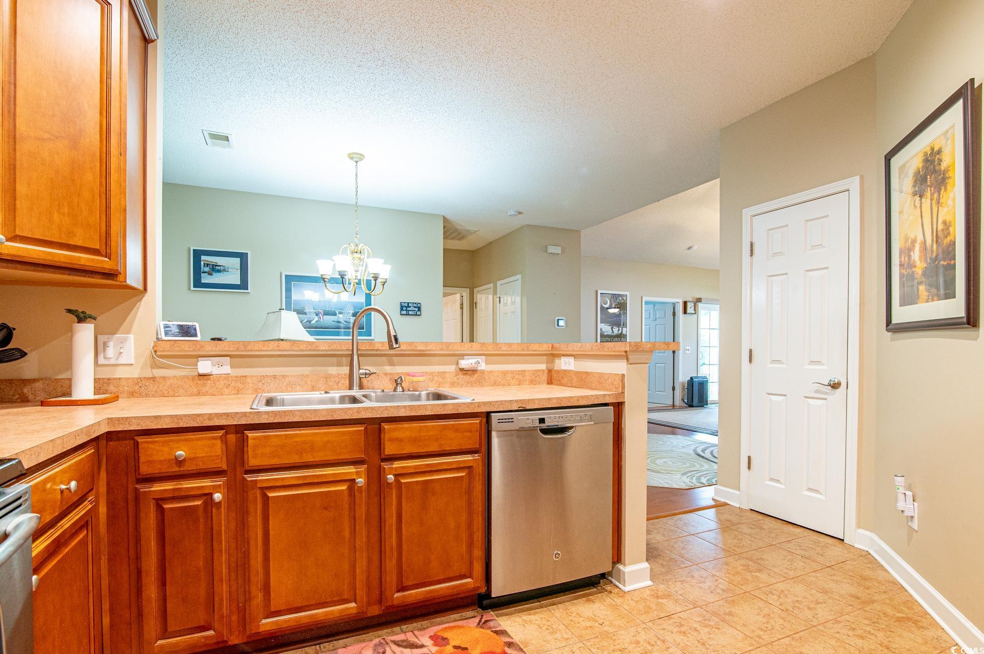 111 Rose Water Loop Myrtle Beach, SC 29588 - Photo 21 of 39 Kitchen featuring dishwasher, a sink, a peninsula,