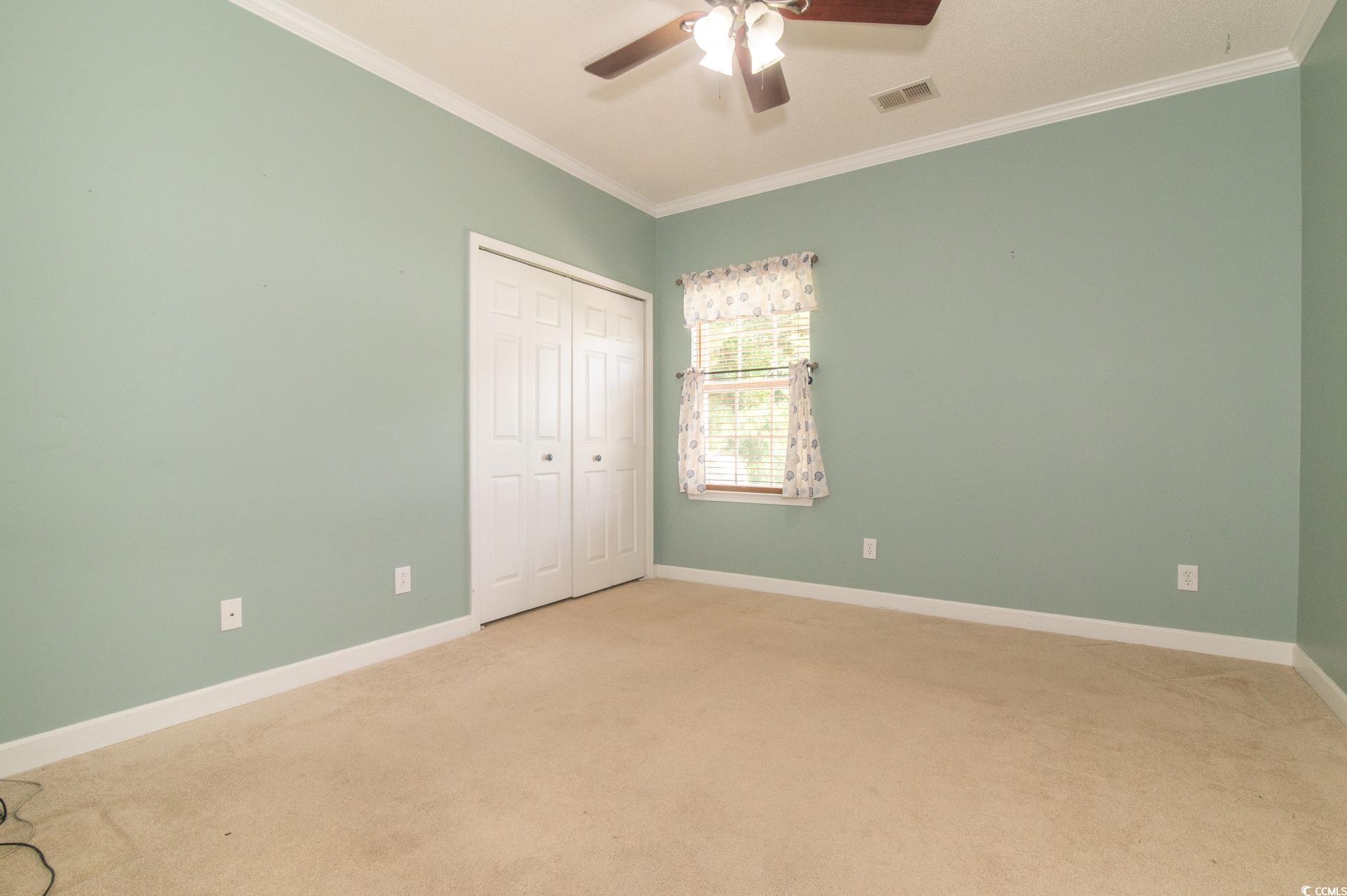 111 Rose Water Loop Myrtle Beach, SC 29588 - Photo 24 of 39 Unfurnished bedroom featuring carpet floors, crown