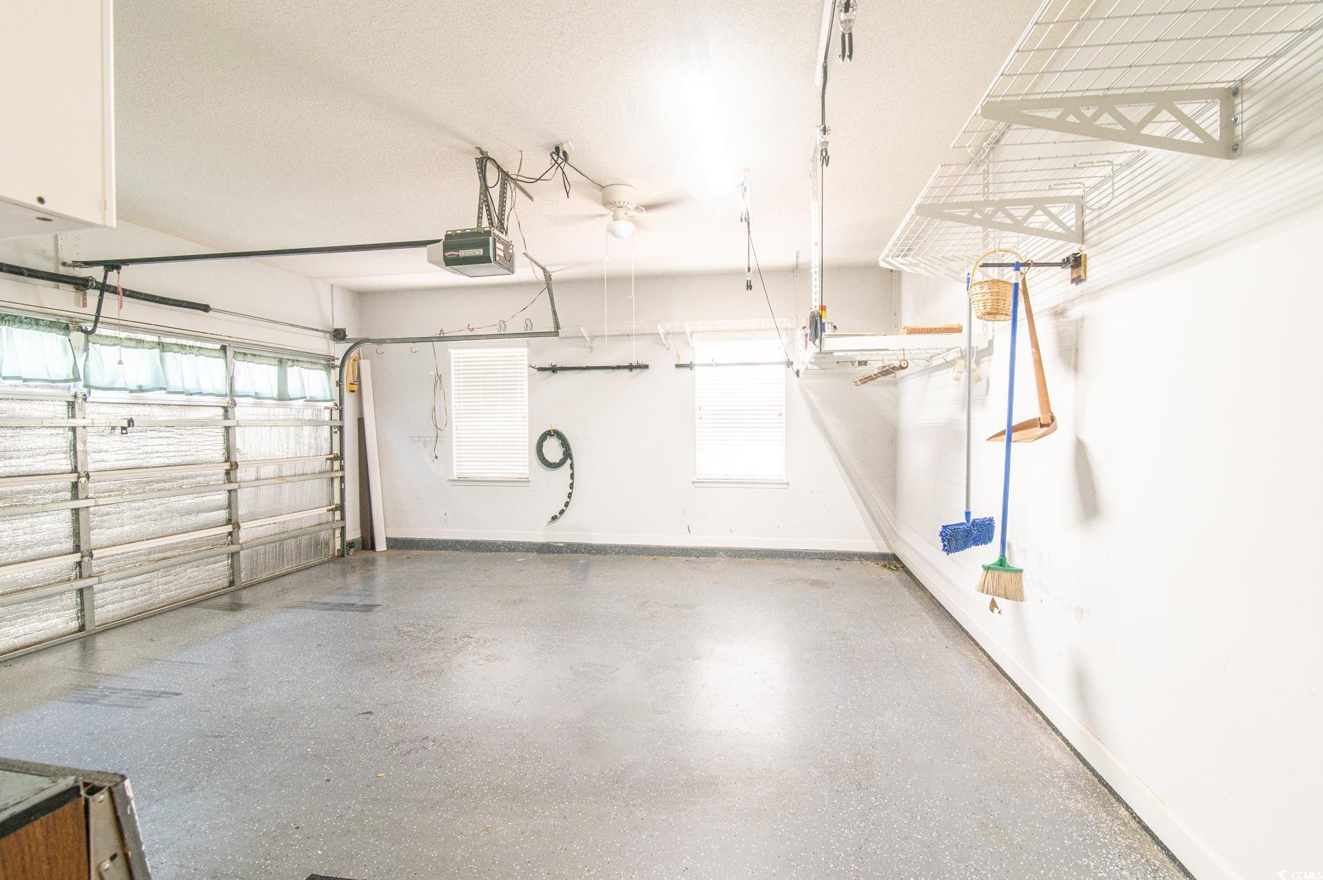 111 Rose Water Loop Myrtle Beach, SC 29588 - Photo 28 of 39 Garage with a garage door opener and baseboards