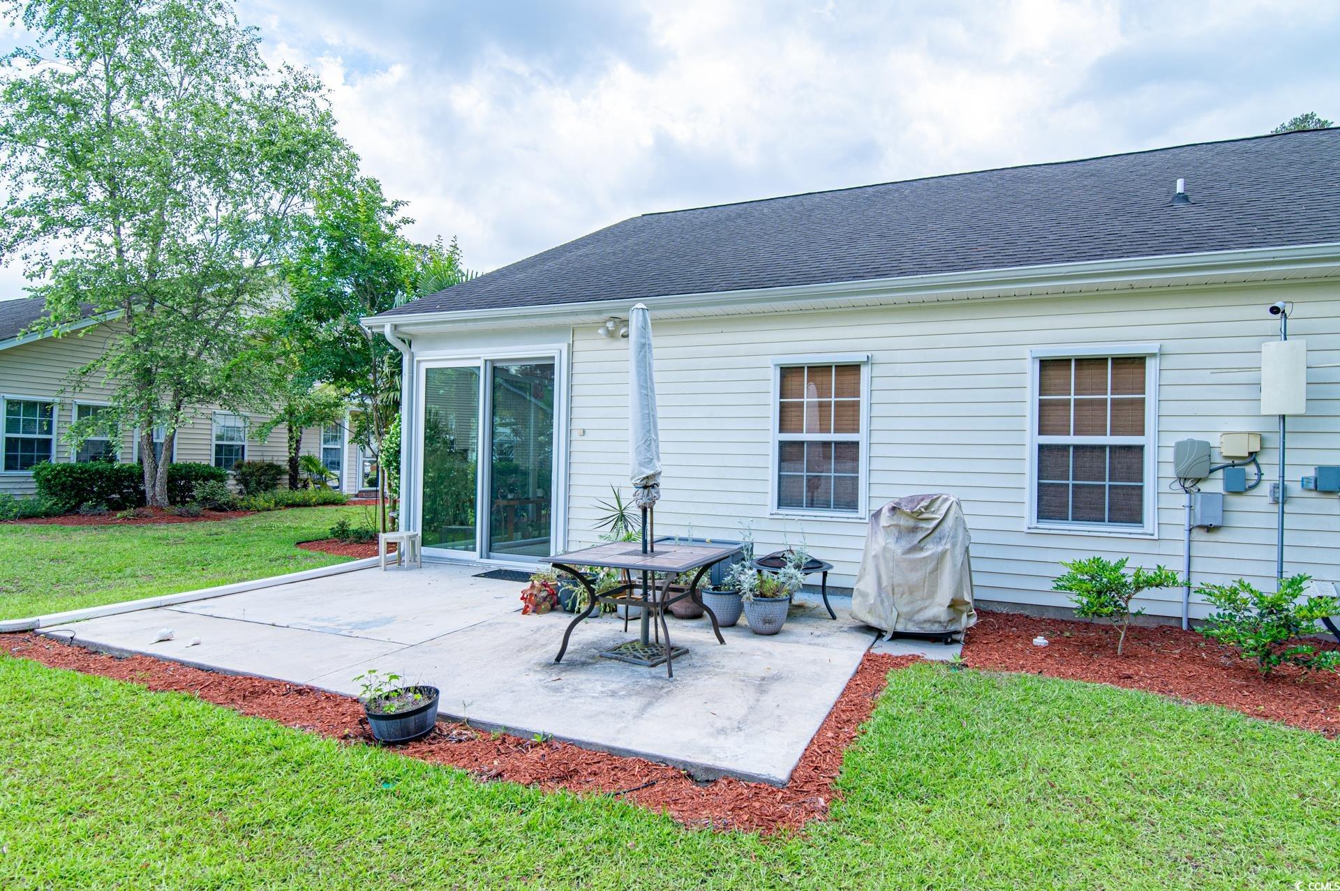 111 Rose Water Loop Myrtle Beach, SC 29588 - Photo 5 of 39 Rear view of property featuring a patio area, a la