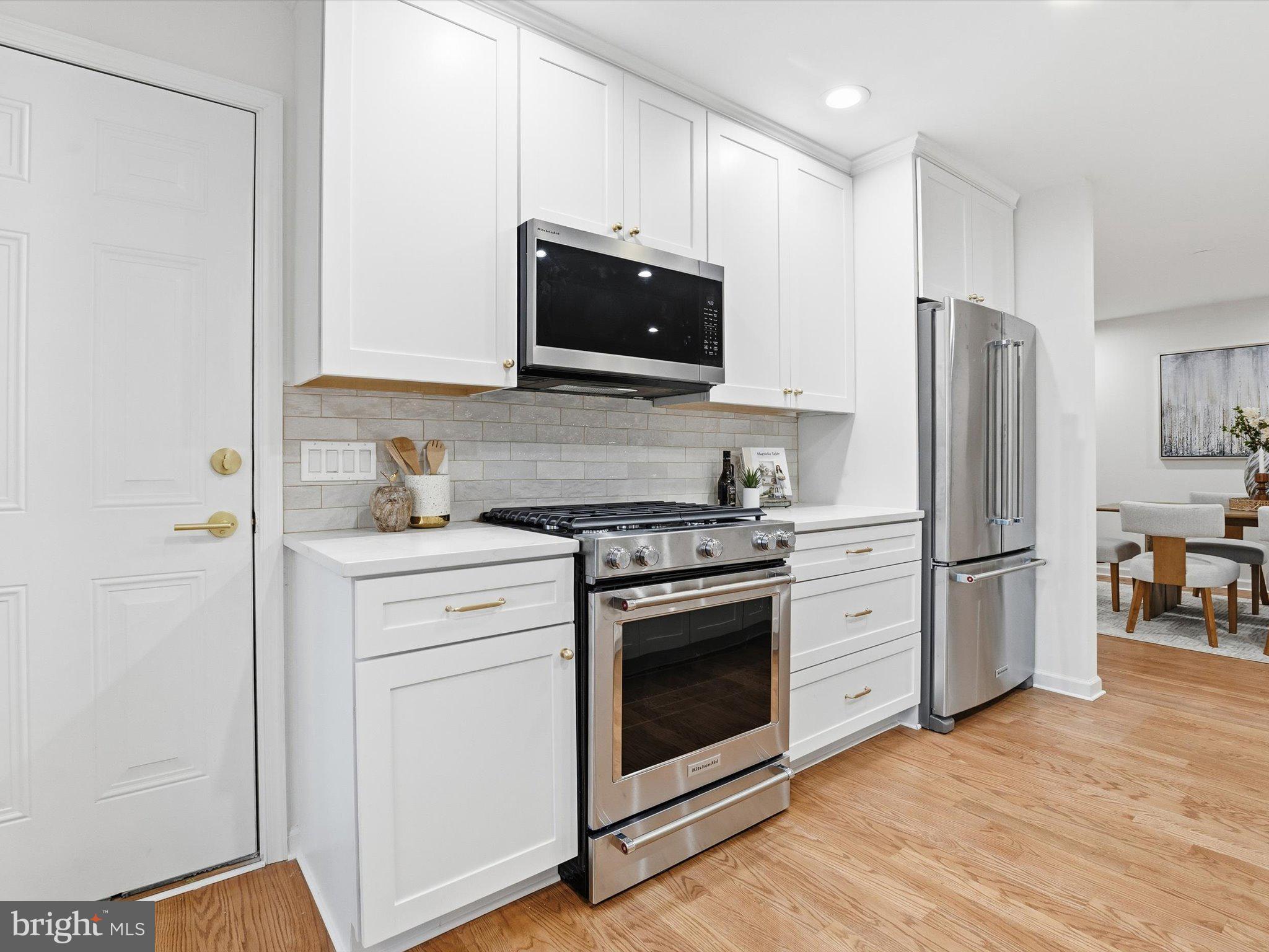 2133 Freda Drive Vienna, VA 22181 - Photo 6 of 45 a kitchen with stainless steel appliances white cabinets white stove a microwave and a refrigerator